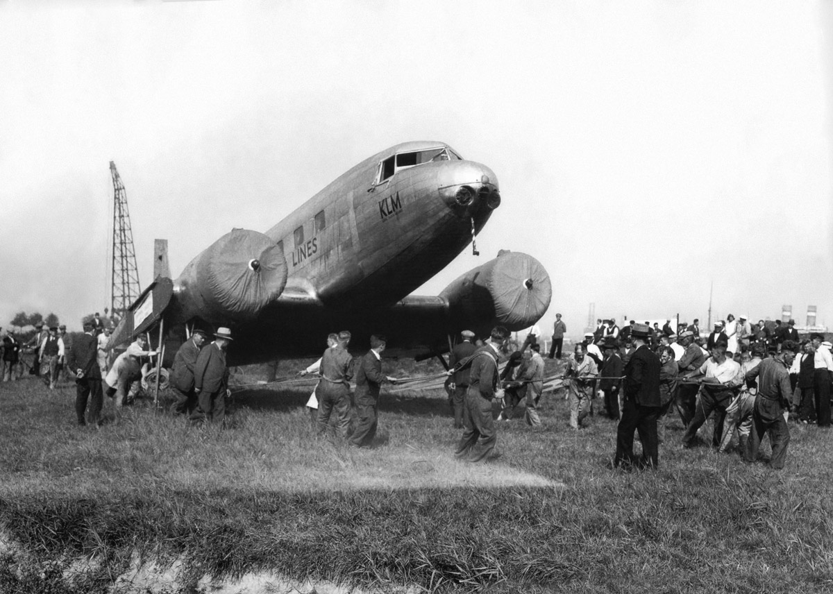  DC-2 (PH-AJU) being hauled from the Waalhaven docks (Rotterdam) to the nearby airport for reassembly by the Fokker company 