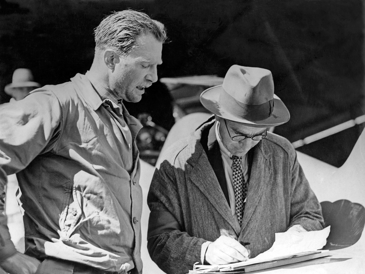 Pilot of the de Havilland DH.88 Comet 'Grosvenor House', Charles Scott, speaking with the official timekeeper at Charleville, Queensland 