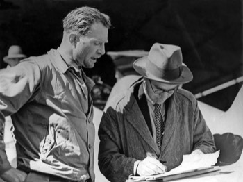  Pilot of the de Havilland DH.88 Comet 'Grosvenor House', Charles Scott, speaking with the official timekeeper at Charleville, Queensland 